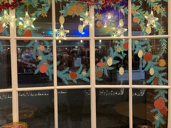 Shop window decorated with painted foliage and fruit