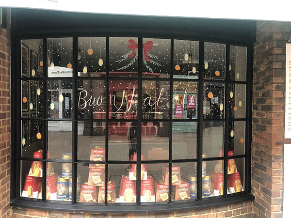 Shop front with hand-painted window lettering and illustration