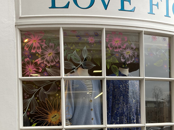 Shop window with large painted flower illustrations
